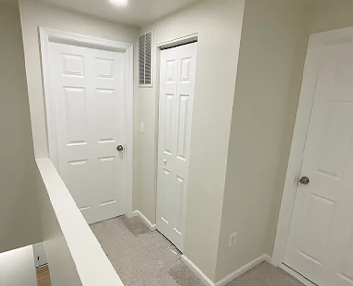Small repairs and door replacement project with white interior doors and wood flooring in Maryland