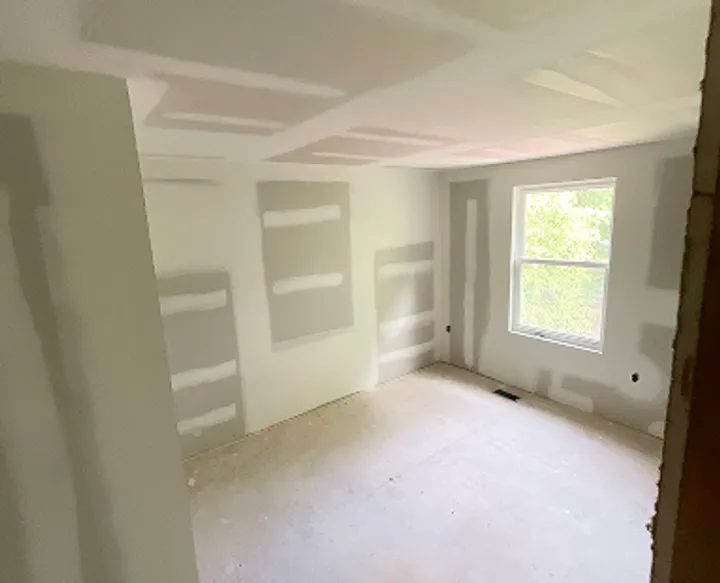 Drywall renovation with smooth wall finishing and white trim in Maryland