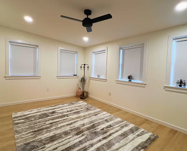 Interior painting with light blue walls and new wood flooring installation in Maryland